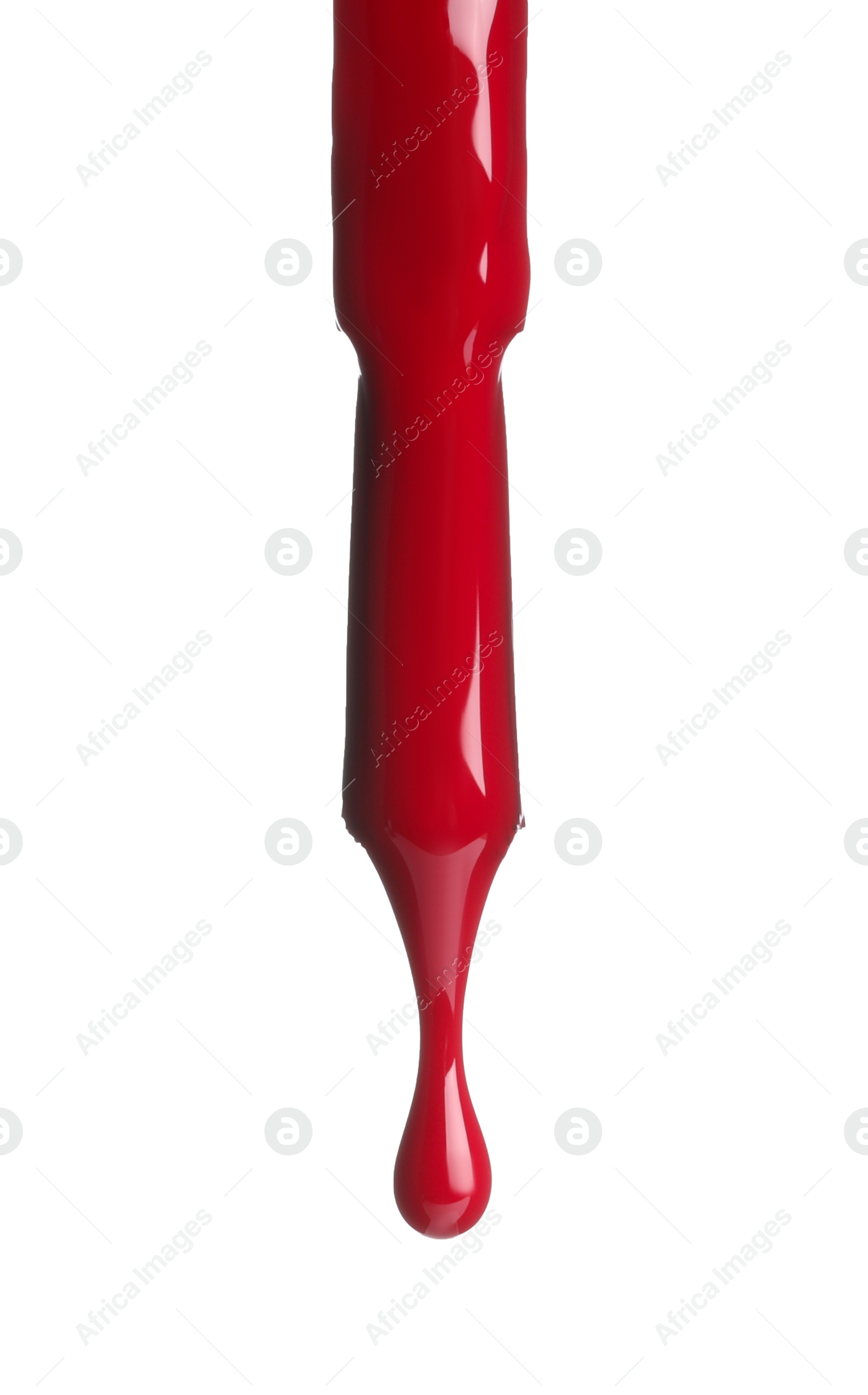 Photo of Red nail polish dripping from brush isolated on white