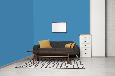 Stylish living room interior with comfortable sofa and coffee table