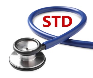 Text STD and stethoscope on white background, closeup