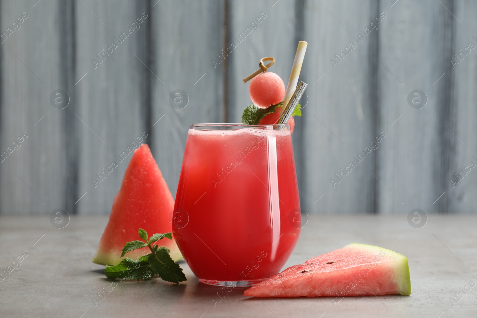 Photo of Delicious fresh watermelon drink on grey table