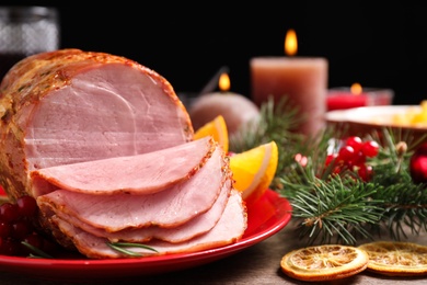 Plate with delicious ham served on wooden table, closeup. Christmas dinner