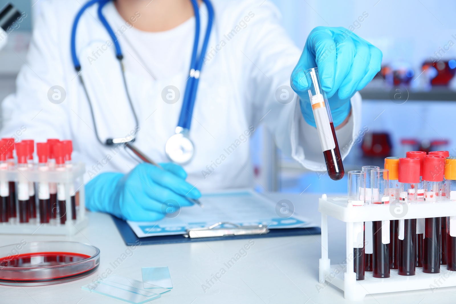 Photo of Female scientist working at table in laboratory. Research and analysis