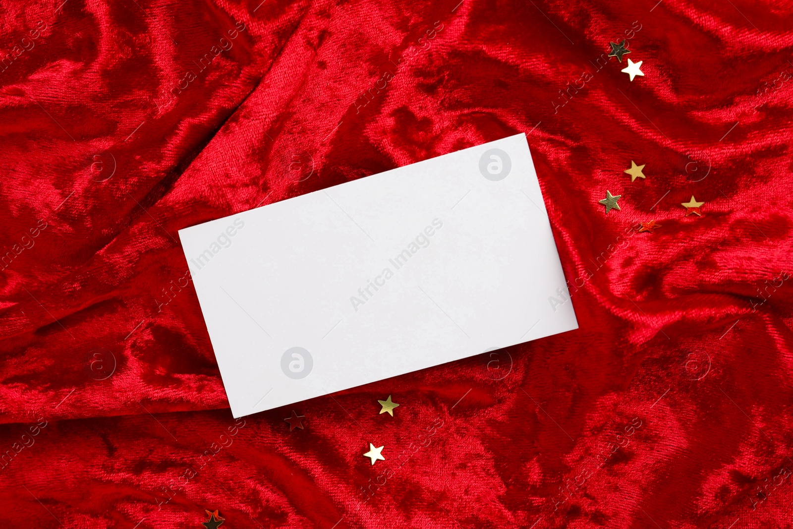 Photo of Blank business card on red fabric, top view. Mockup for design