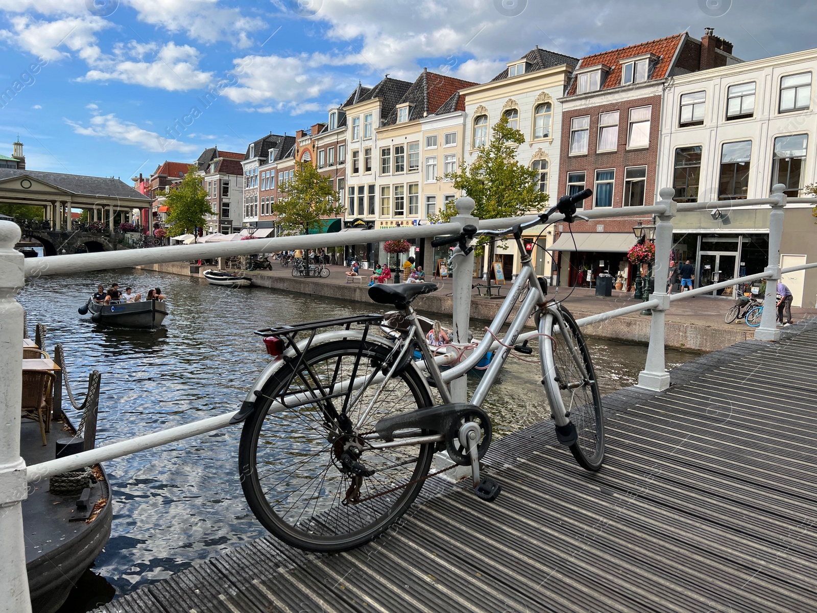 Photo of Beautiful view of bicycle on pedestrian bridge near canal in city