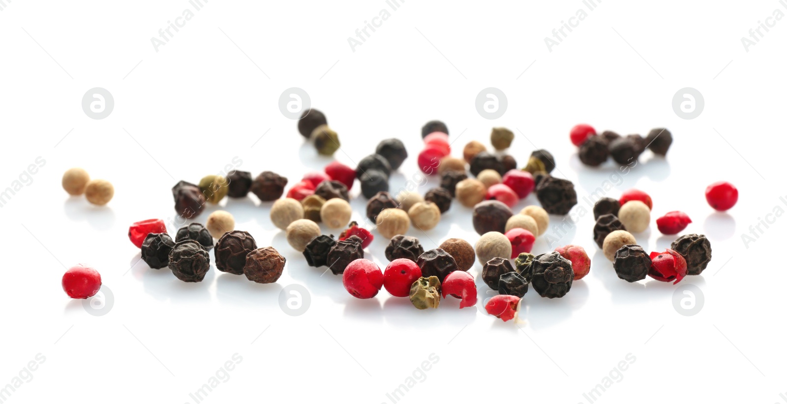 Photo of Mix of different pepper grains on white background