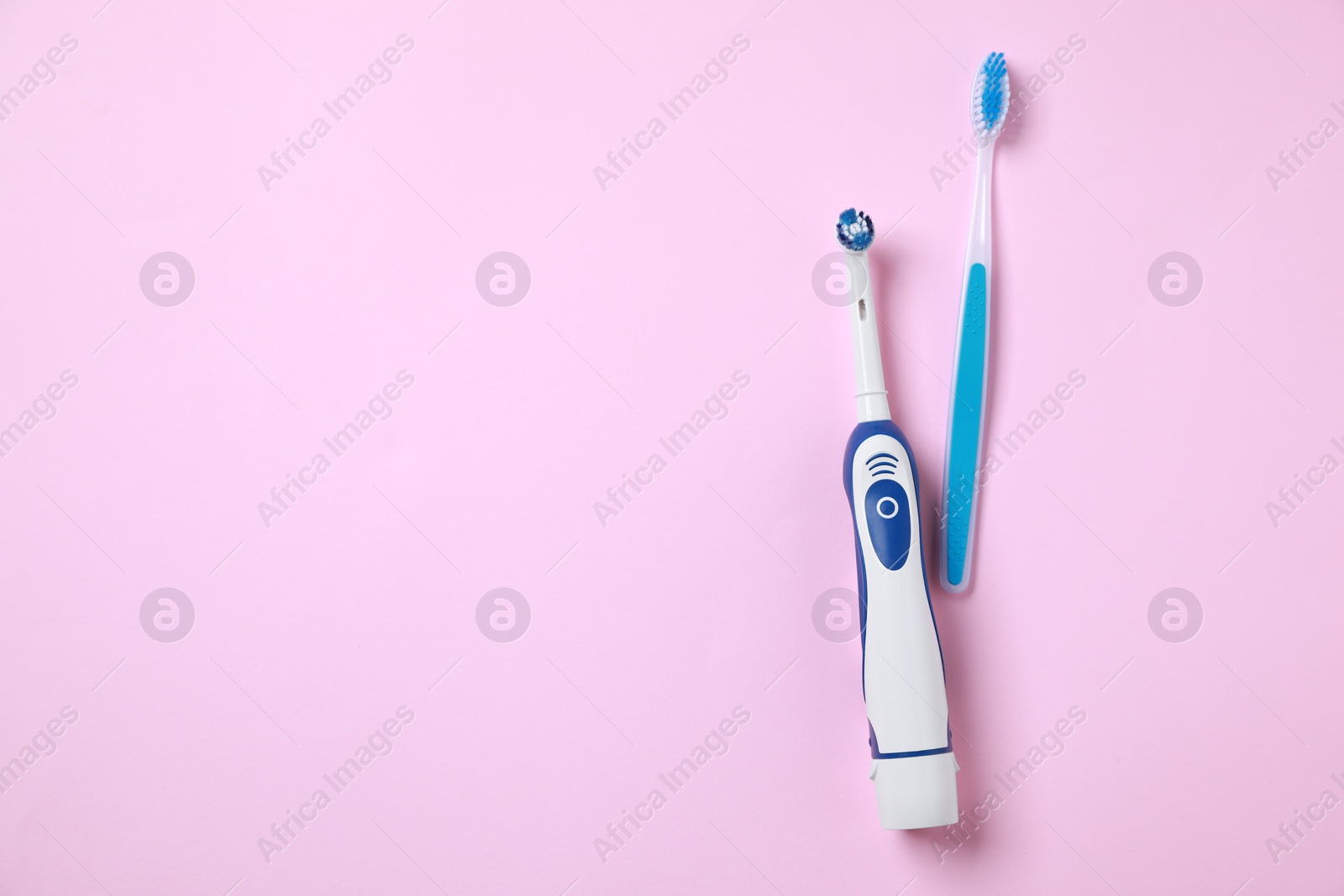 Photo of Electric and plastic toothbrushes on pink background, flat lay. Space for text