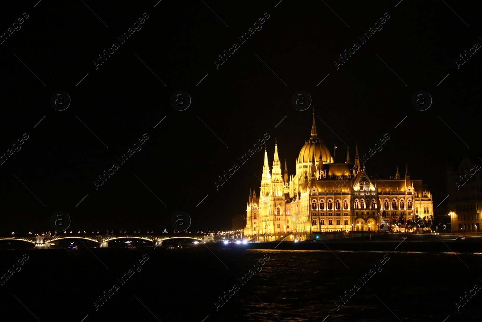 Photo of BUDAPEST, HUNGARY - APRIL 27, 2019: Beautiful night cityscape with illuminated Parliament Building and Margaret Bridge across Danube river