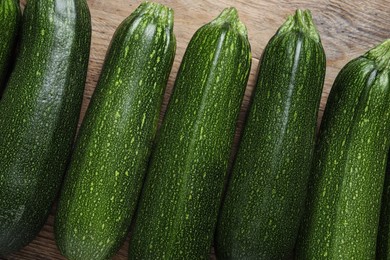 Photo of Raw ripe zucchinis on wooden table, flat lay