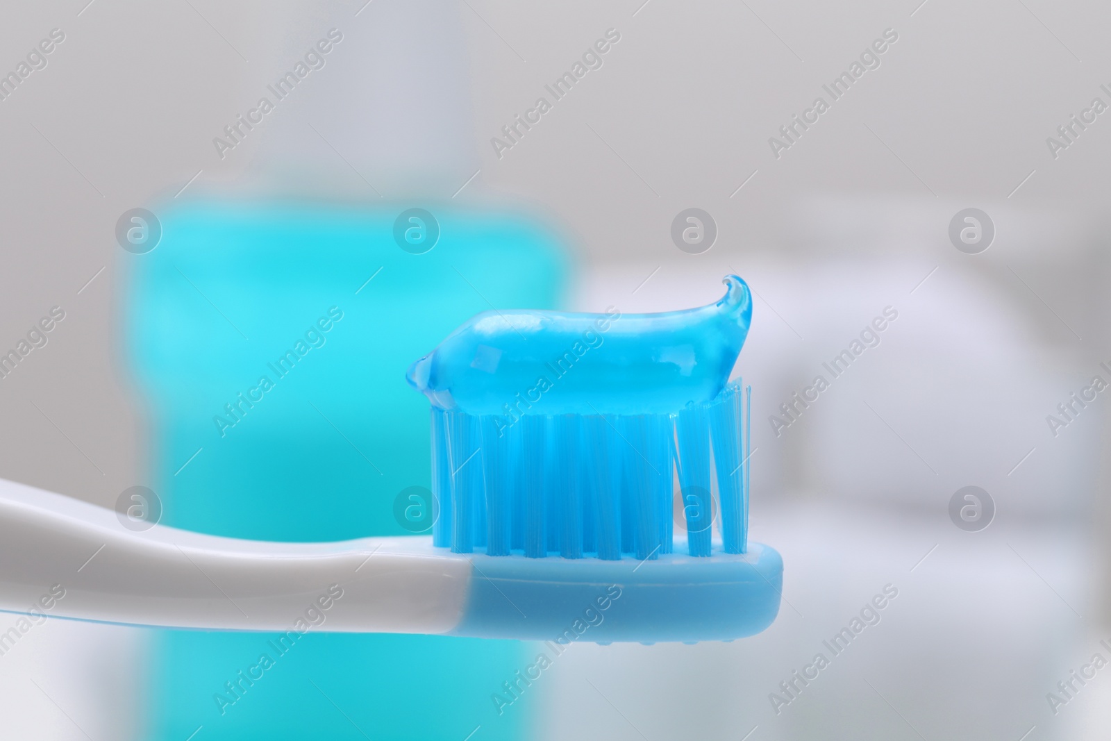 Photo of Toothbrush with paste on blurred background, closeup