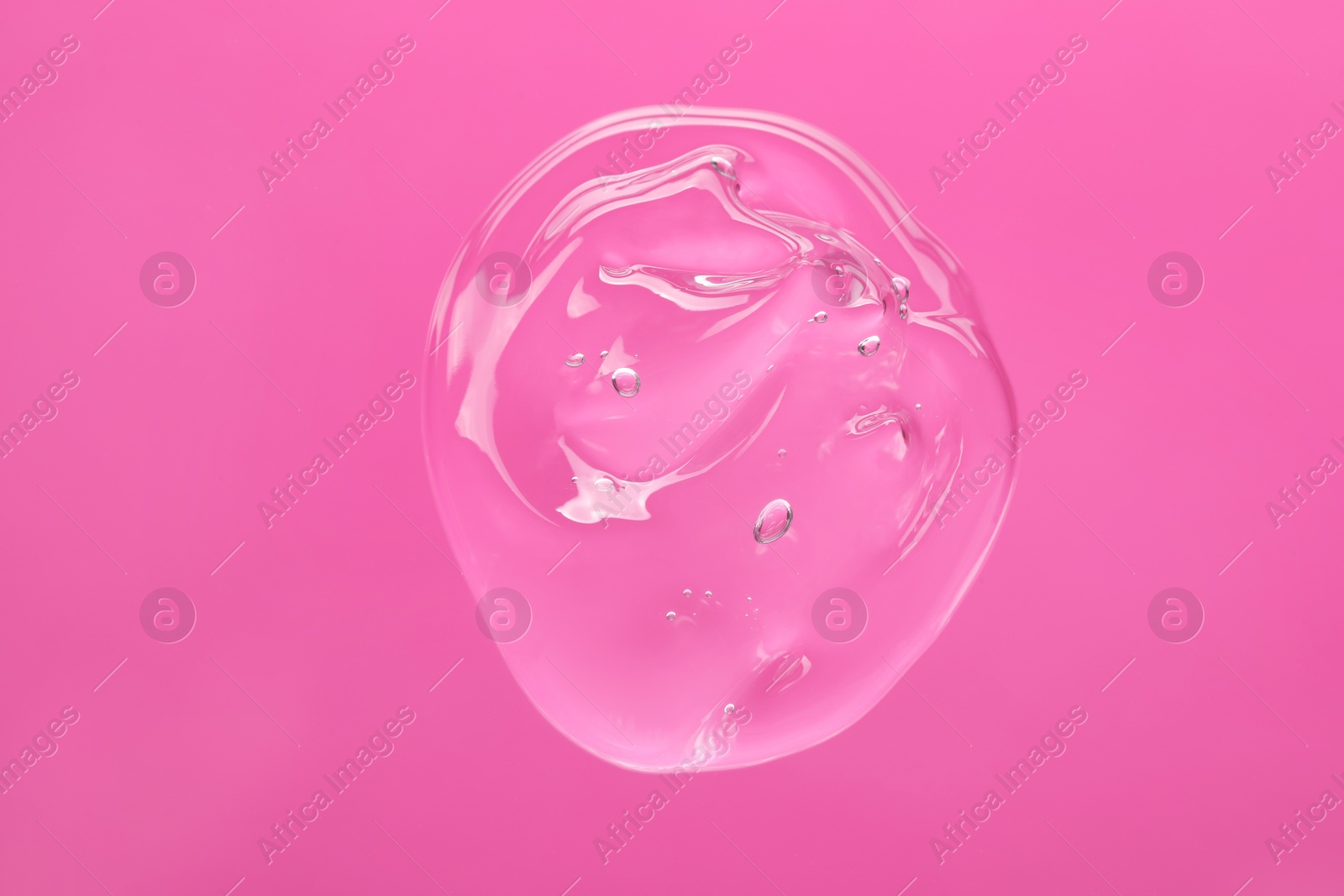 Photo of Sample of cleansing gel on pink background, top view. Cosmetic product