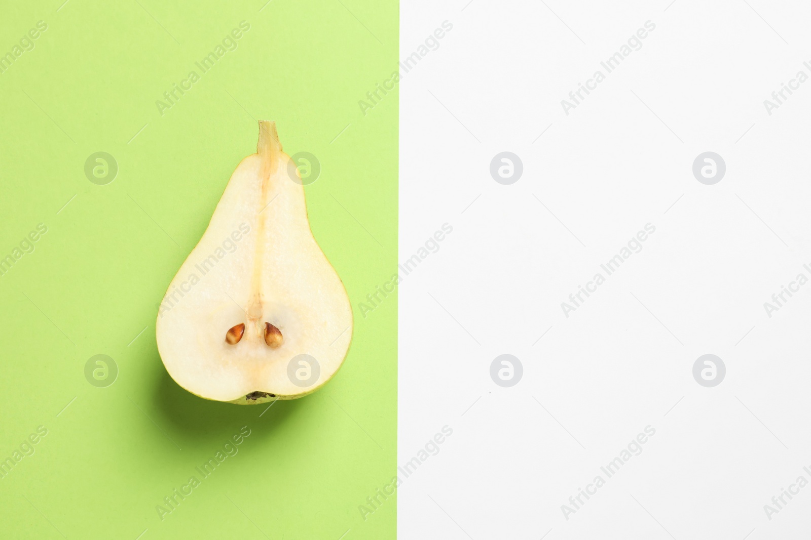 Photo of Ripe juicy pear on color background, top view