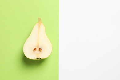 Ripe juicy pear on color background, top view