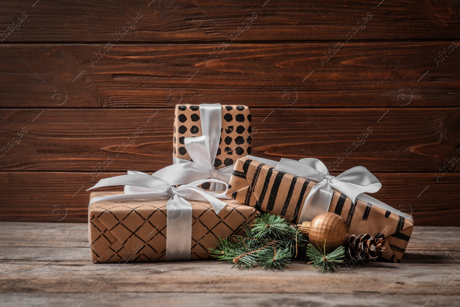 Photo of Beautiful composition with gift box and Christmas decorations on wooden table