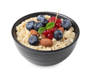 Photo of Bowl of delicious cooked quinoa with almonds, cranberries and blueberries isolated on white