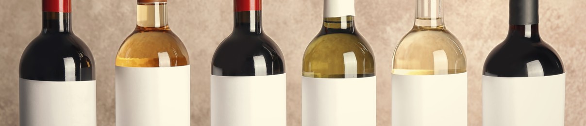 Image of Bottles of different wines, closeup view. Banner design