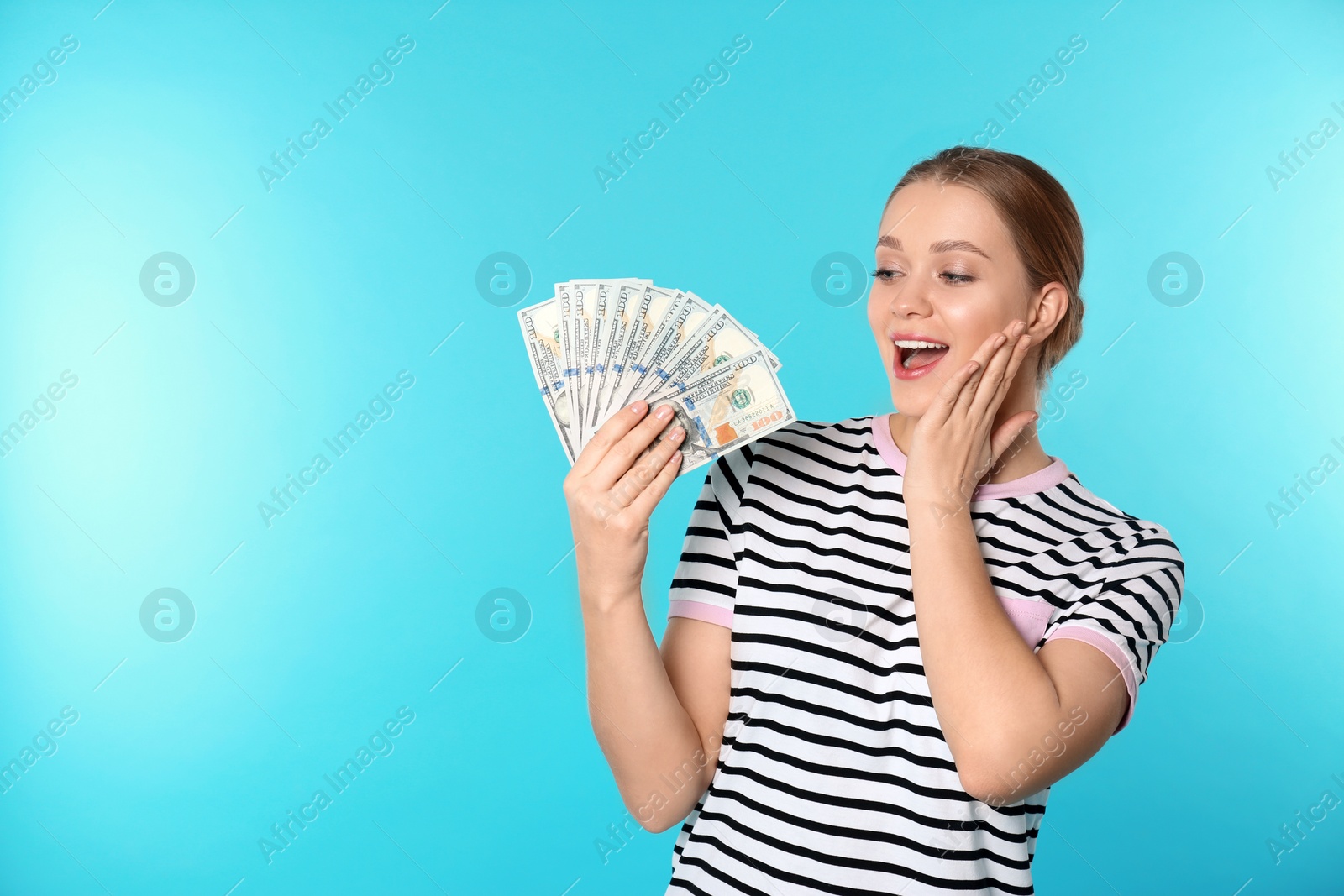 Photo of Portrait of emotional young woman with money on color background. Space for text