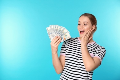 Photo of Portrait of emotional young woman with money on color background. Space for text