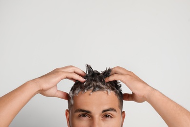 Photo of Man washing hair on white background, closeup