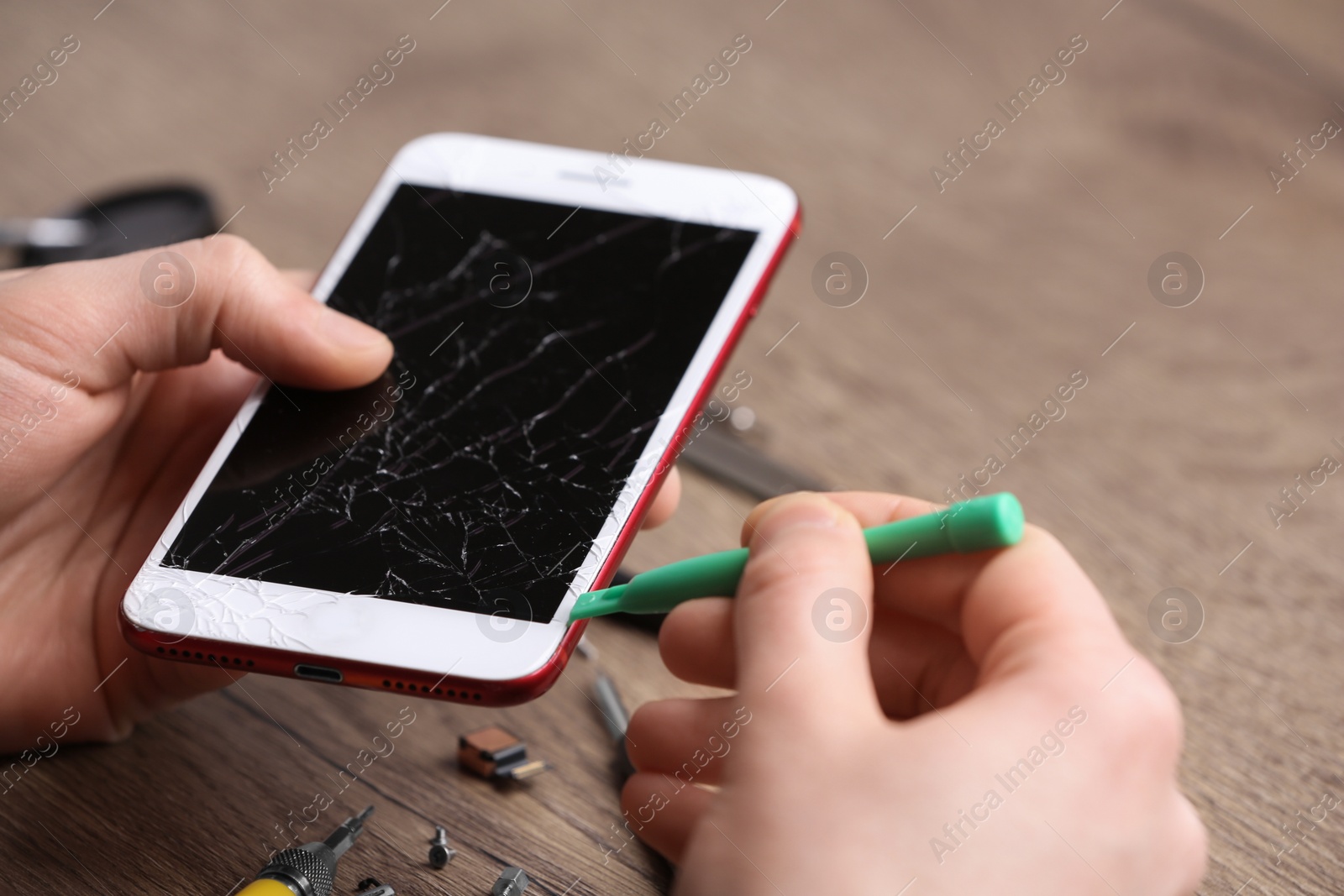 Photo of Technician fixing mobile phone at table, closeup. Device repair service