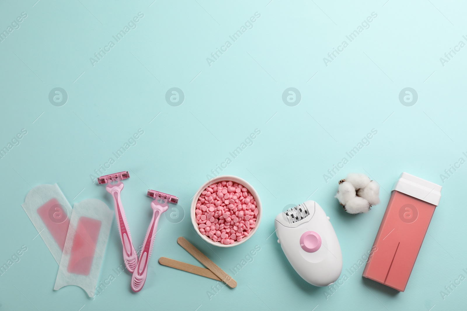 Photo of Set of epilation tools and products on turquoise background, flat lay. Space for text