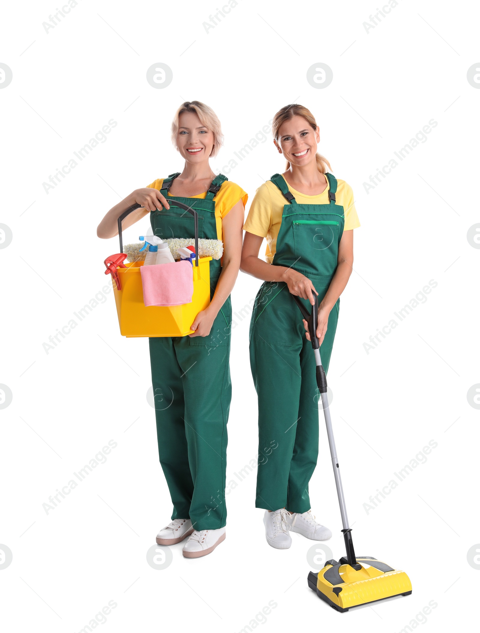 Photo of Female janitors with cleaning equipment on white background