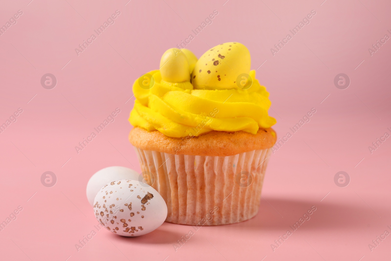 Photo of Tasty cupcake with Easter decor on pink background, closeup