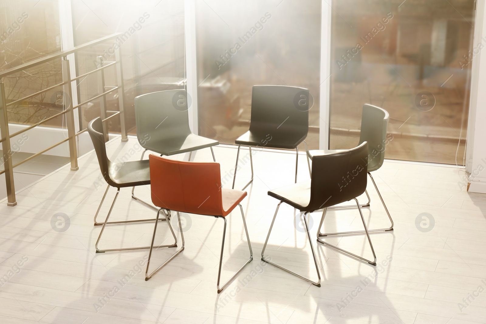 Photo of Chairs prepared for group therapy session in office. Meeting room interior