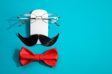 Photo of Flat lay composition with artificial moustache and glasses on light blue background, space for text