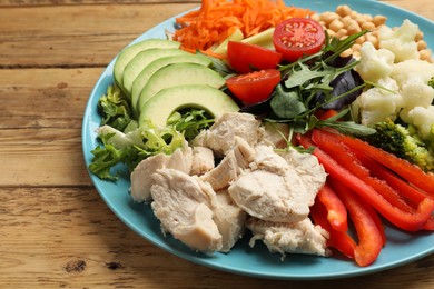 Photo of Balanced diet and healthy foods. Plate with different delicious products on wooden table, closeup