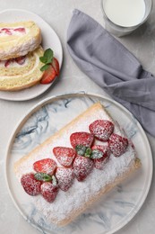 Delicious cake roll with strawberries and milk on light gray table, flat lay