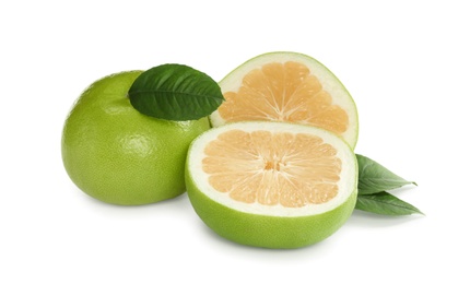 Photo of Whole and cut sweetie fruits with green leaves on white background