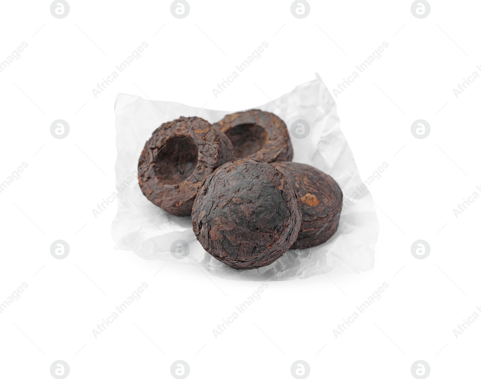 Photo of Cake shaped traditional Chinese pu-erh tea in paper wrap isolated on white