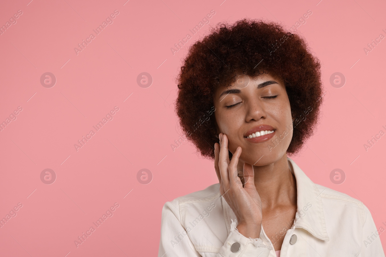 Photo of Portrait of happy young woman on pink background. Space for text