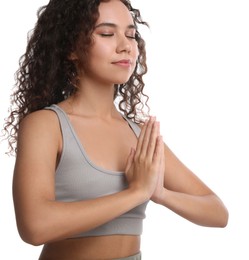 Photo of Beautiful African-American woman meditating on white background