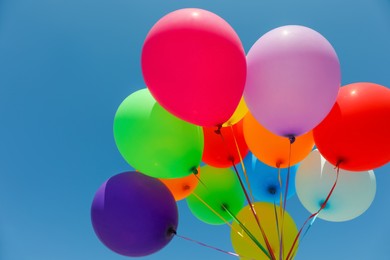 Photo of Bunch of colorful balloons against blue sky