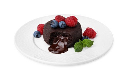 Photo of Plate with delicious chocolate fondant, berries and mint isolated on white