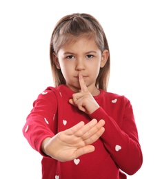 Photo of Little girl showing HUSH gesture in sign language on white background