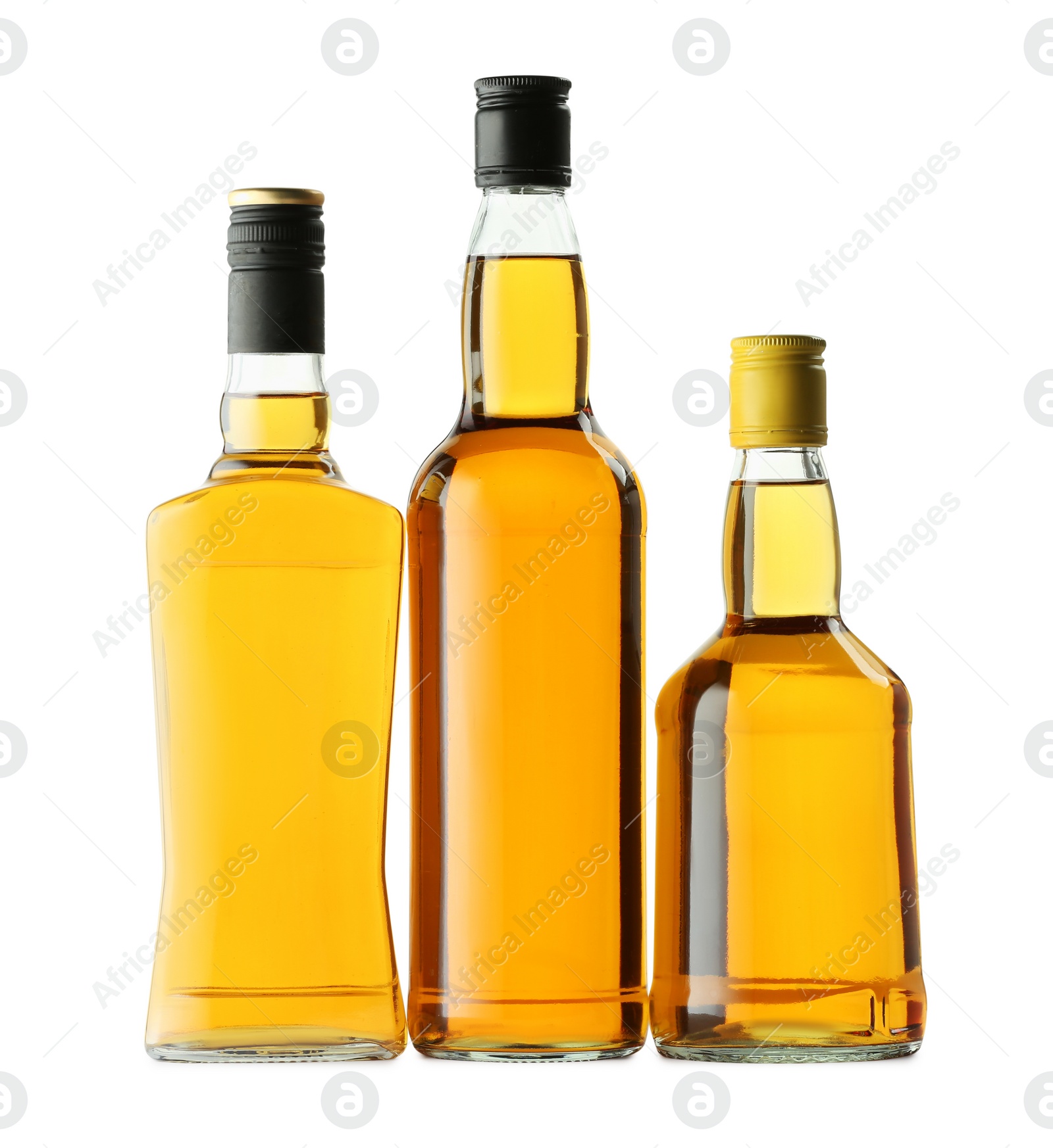 Photo of Different sorts of whiskey in glass bottles isolated on white