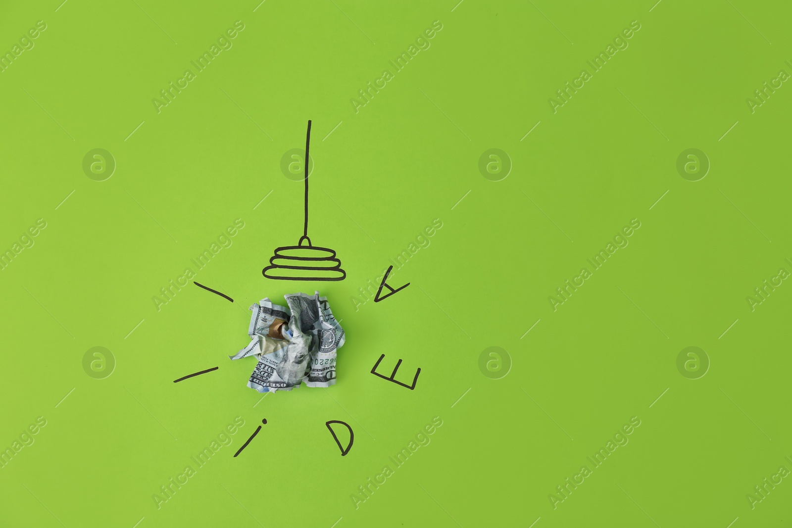 Photo of Composition with crumpled banknote, drawing of lamp bulb and word IDEA on color background. Space for text