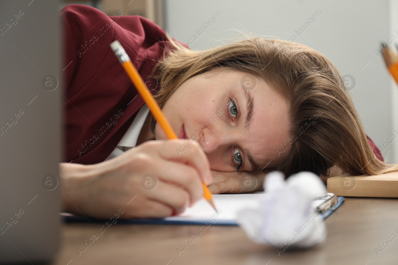 Photo of Sad businesswoman working at wooden table in office