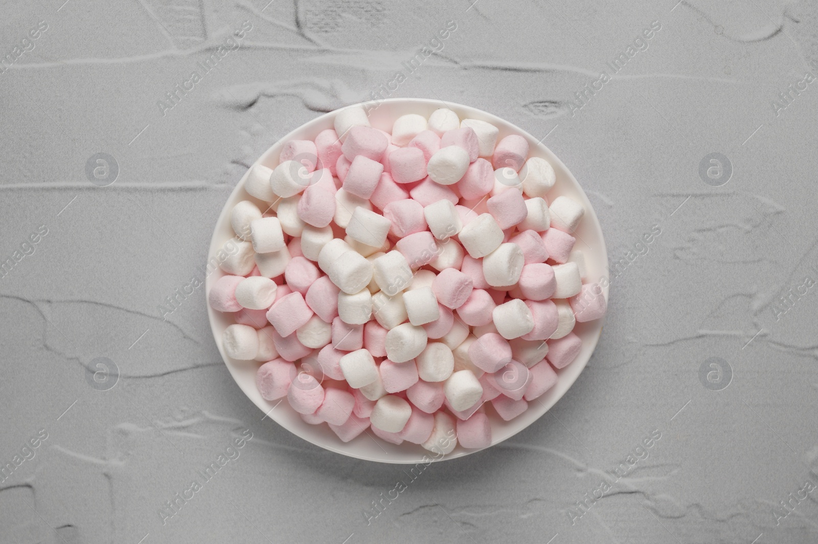 Photo of Delicious marshmallows on light textured table, top view