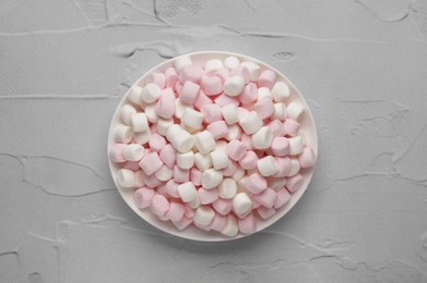 Delicious marshmallows on light textured table, top view