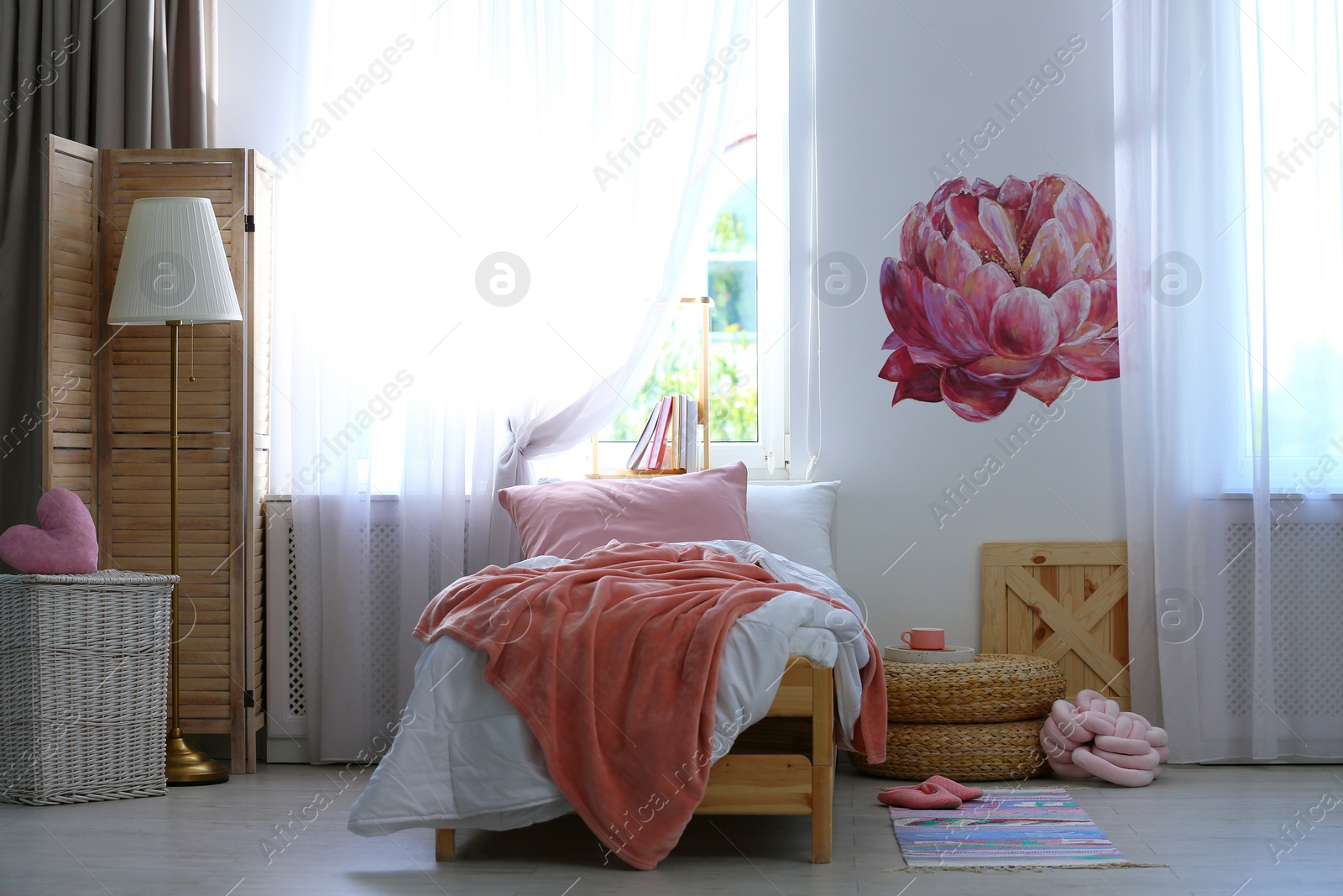 Photo of Stylish room interior with comfortable bed near decorated wall