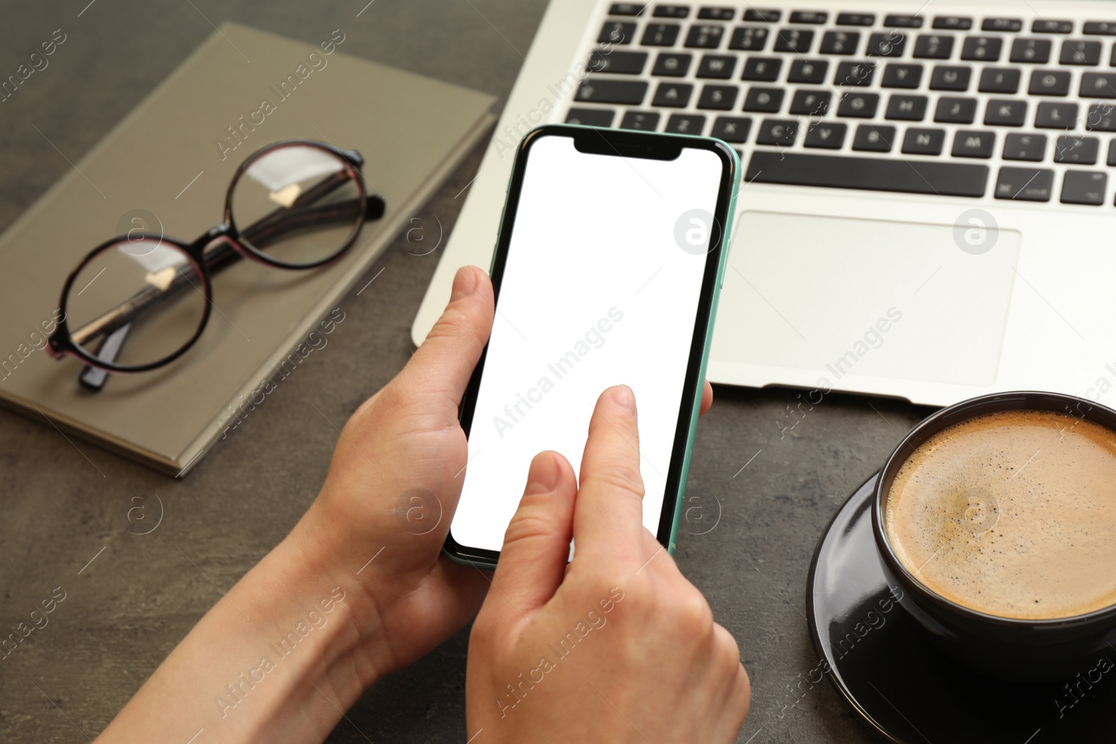 Photo of MYKOLAIV, UKRAINE - JULY 8, 2020: Woman using Iphone 11 Pro Max with blank screen at workplace, closeup