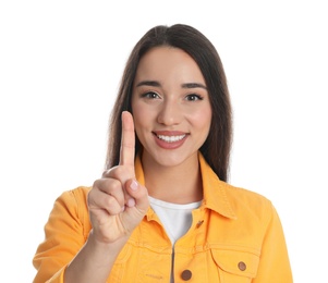 Photo of Woman in yellow jacket showing number one with her hand on white background