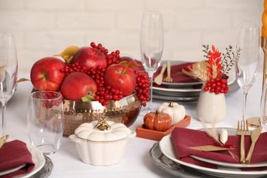 Photo of Elegant festive setting with autumn decor on table