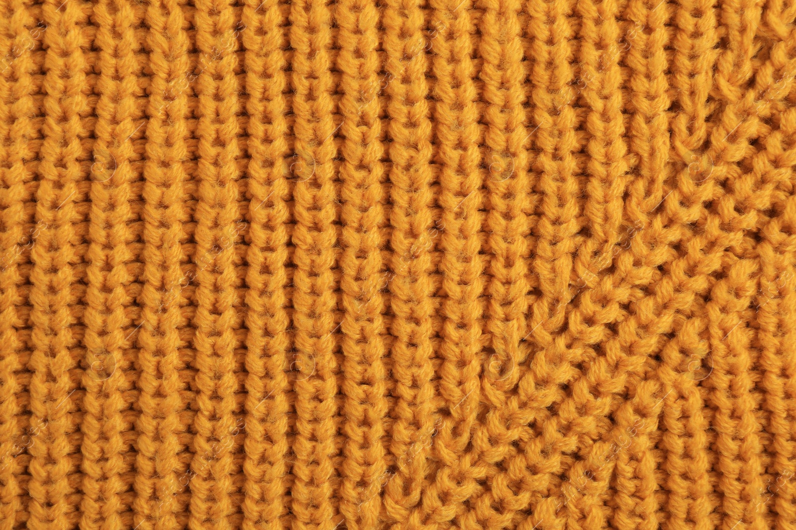 Photo of Beautiful orange knitted fabric as background, top view