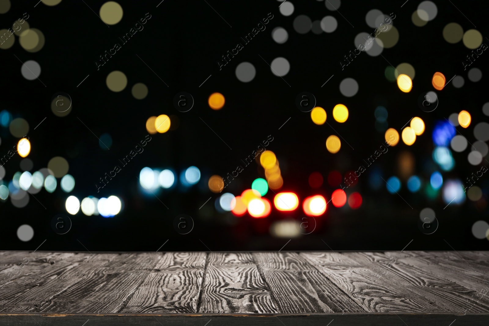 Image of Empty wooden surface against blurred Christmas lights. Bokeh effect 