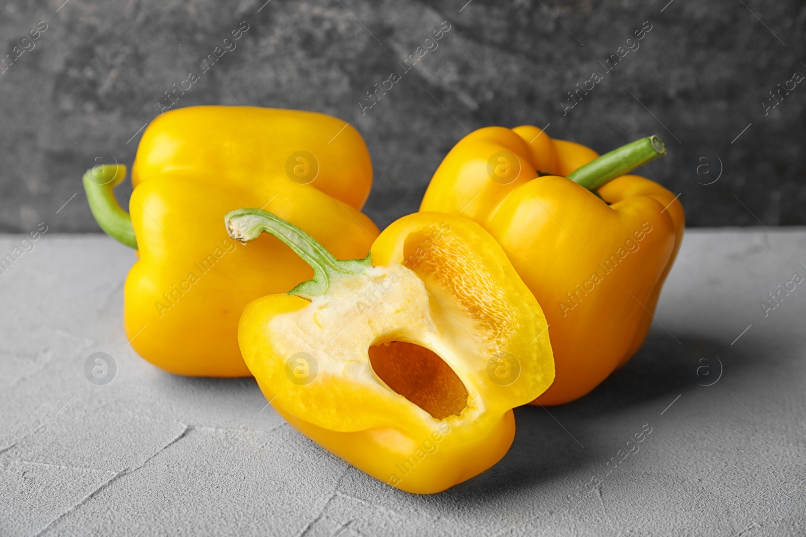 Photo of Raw ripe paprika peppers on grey table