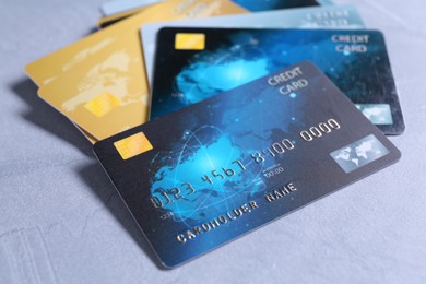 Photo of Credit cards on grey textured table, closeup